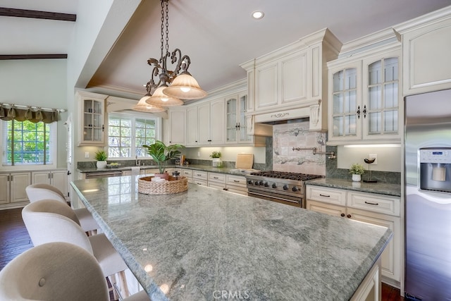 9230 Whitney Way, Cypress, CA 90630 - kitchen with stainless steel appliances, a center island, light stone counters, a breakfast bar area, and recessed lighting