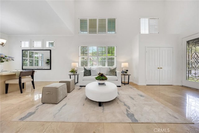 4450 Autumn Glow Ct, Chino Hills, CA 91709 - living area with a high ceiling, plenty of natural light, marble finish floors, and a chandelier