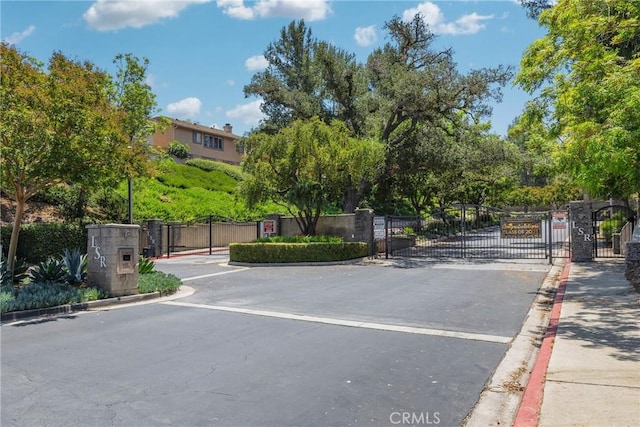 4450 Autumn Glow Ct, Chino Hills, CA 91709 - view of asphalt road with curbs, a gate, and a gated entry