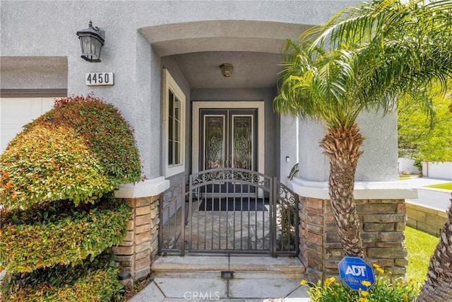 4450 Autumn Glow Ct, Chino Hills, CA 91709 - doorway to property featuring stucco siding and a gate