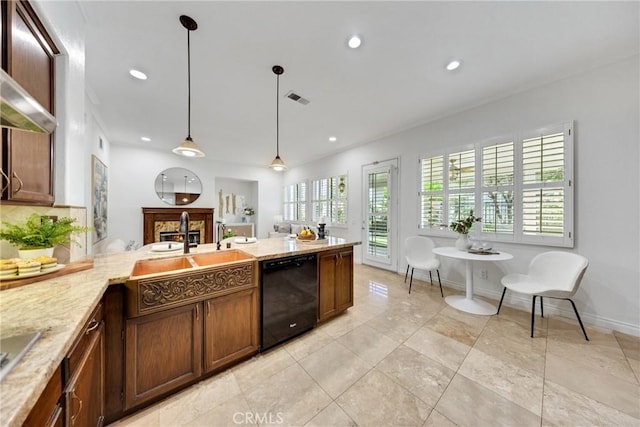 4450 Autumn Glow Ct, Chino Hills, CA 91709 - kitchen with black appliances, pendant lighting, a warm lit fireplace, recessed lighting, and light stone countertops
