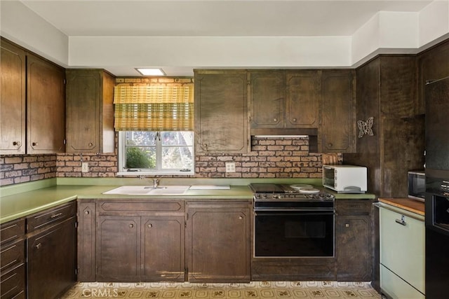 1603 Colusa St, Corning, CA 96021 - kitchen with electric range oven, light countertops, and dark brown cabinetry