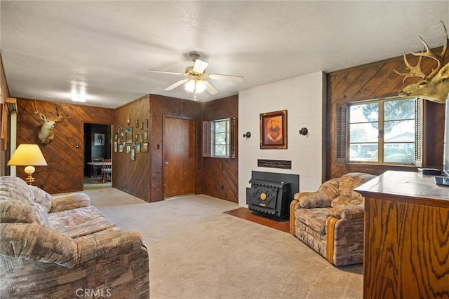 1603 Colusa St, Corning, CA 96021 - living area with wood walls, a wood stove, light colored carpet, plenty of natural light, and ceiling fan