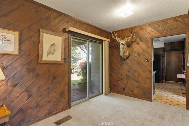 1603 Colusa St, Corning, CA 96021 - carpeted empty room featuring wooden walls and a textured ceiling