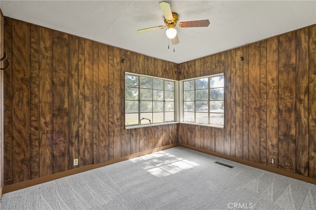 1603 Colusa St, Corning, CA 96021 - spare room featuring carpet flooring, ceiling fan, and wood walls