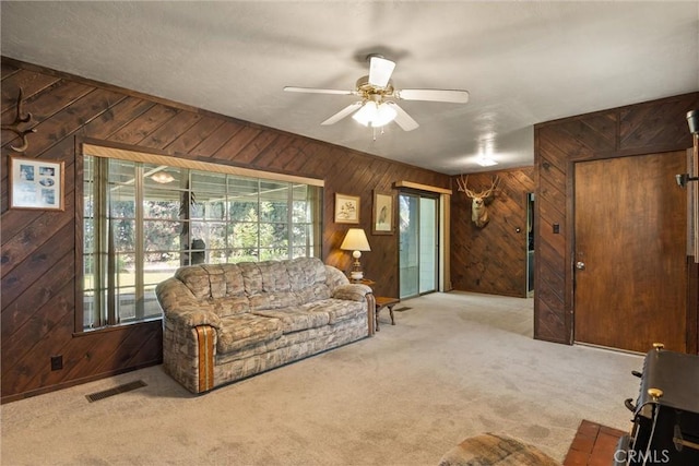 1603 Colusa St, Corning, CA 96021 - living room featuring wooden walls, carpet flooring, and ceiling fan