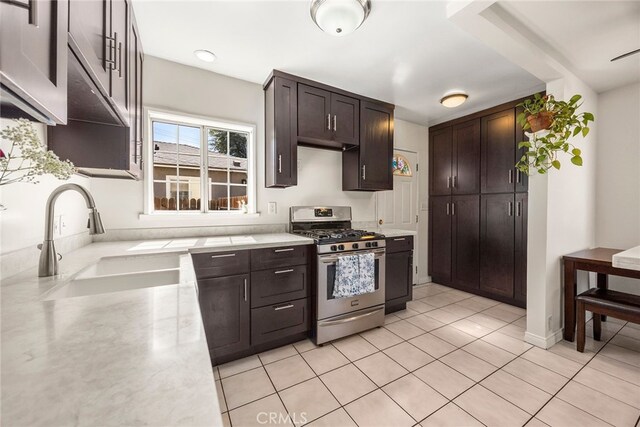 2051 Royal Oaks Dr, Duarte, CA 91010 - kitchen featuring stainless steel range with gas stovetop, dark brown cabinets, and light tile patterned floors