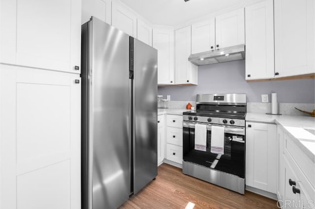 1157 Emerald Ave, El Cajon, CA 92020 - kitchen with stainless steel appliances, under cabinet range hood, light countertops, and white cabinetry