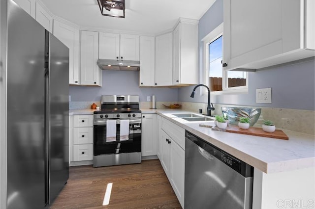 1157 Emerald Ave, El Cajon, CA 92020 - kitchen featuring stainless steel appliances, under cabinet range hood, light countertops, white cabinets, and dark wood-style flooring