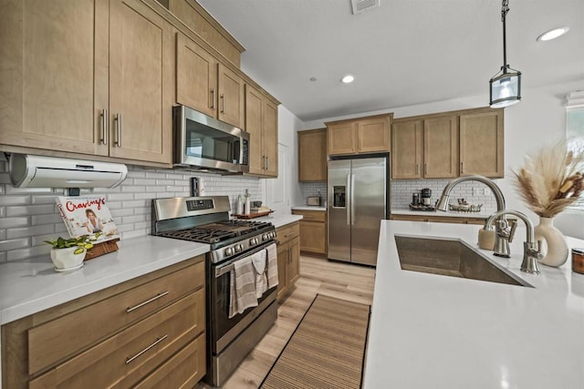 32755 Brunello Way, Temecula, CA 92591 - kitchen with appliances with stainless steel finishes, recessed lighting, light countertops, backsplash, and hanging light fixtures
