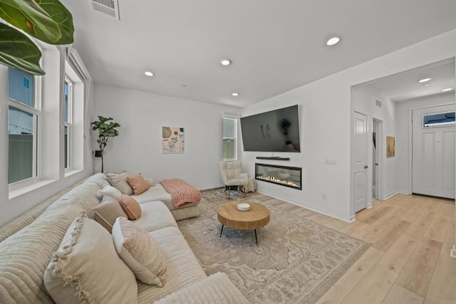 32755 Brunello Way, Temecula, CA 92591 - living area featuring recessed lighting, light wood-style flooring, and a glass covered fireplace
