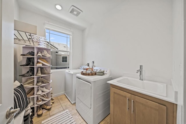 32755 Brunello Way, Temecula, CA 92591 - laundry area with washing machine and dryer, cabinet space, and light tile patterned floors