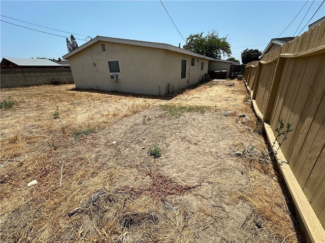 820 S Kenmore St, Anaheim, CA 92804 - view of side of property with a fenced backyard, stucco siding, and cooling unit