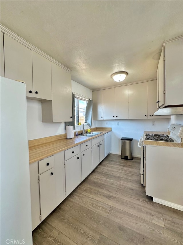 820 S Kenmore St, Anaheim, CA 92804 - kitchen featuring white appliances, light wood-style floors, light countertops, white cabinetry, and a textured ceiling