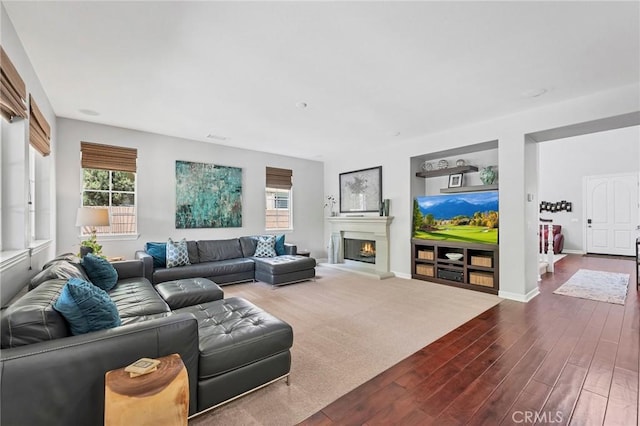 46379 Canyon Crest Ct, Temecula, CA 92592 - living room with plenty of natural light, dark wood finished floors, and a lit fireplace