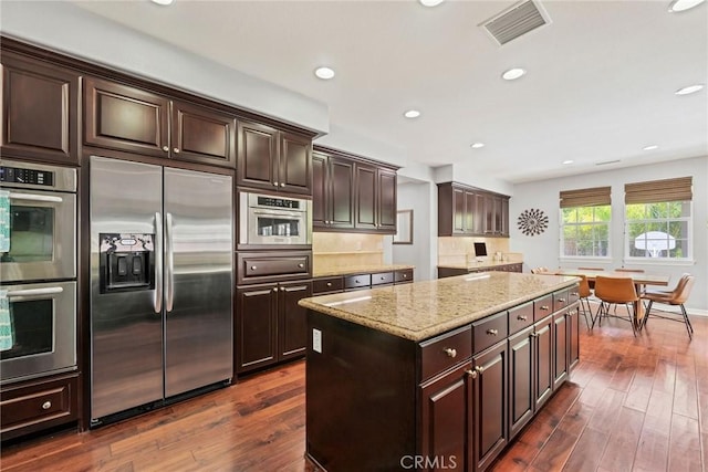 46379 Canyon Crest Ct, Temecula, CA 92592 - kitchen with stainless steel appliances, light stone counters, a kitchen island, dark wood-style floors, and recessed lighting