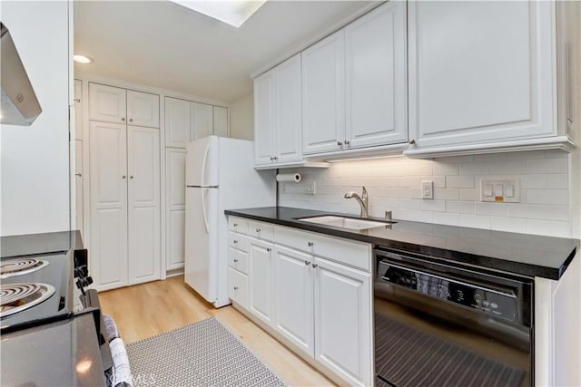 3205 Via Buena Unit B, Laguna Woods, CA 92637 - kitchen with black dishwasher, wall chimney exhaust hood, dark countertops, range with electric stovetop, and white cabinetry