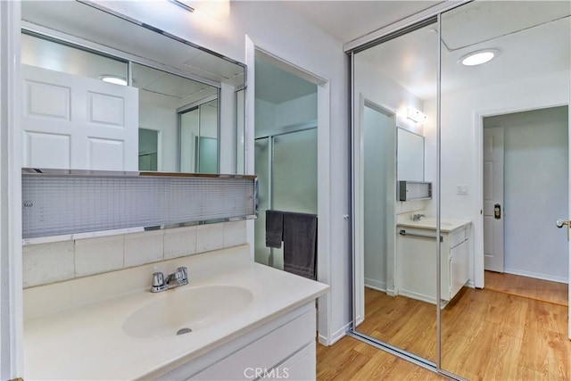 3205 Via Buena Unit B, Laguna Woods, CA 92637 - full bath featuring wood finished floors, vanity, and a shower with shower door