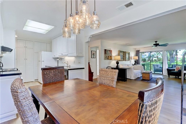 3205 Via Buena Unit B, Laguna Woods, CA 92637 - dining room with ceiling fan, light wood-style floors, and a skylight