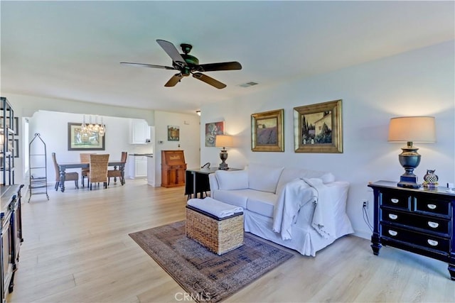3205 Via Buena Unit B, Laguna Woods, CA 92637 - living room with a chandelier, a ceiling fan, and light wood finished floors