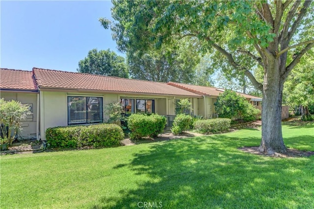3205 Via Buena Unit B, Laguna Woods, CA 92637 - ranch-style home featuring a tile roof, stucco siding, and a front yard