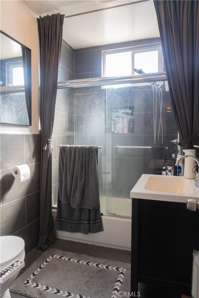 3801 Whiteside St, Los Angeles, CA 90063 - bathroom featuring combined bath / shower with glass door, vanity, tile walls, and tile patterned flooring