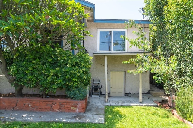 3801 Whiteside St, Los Angeles, CA 90063 - rear view of property with stucco siding and a yard