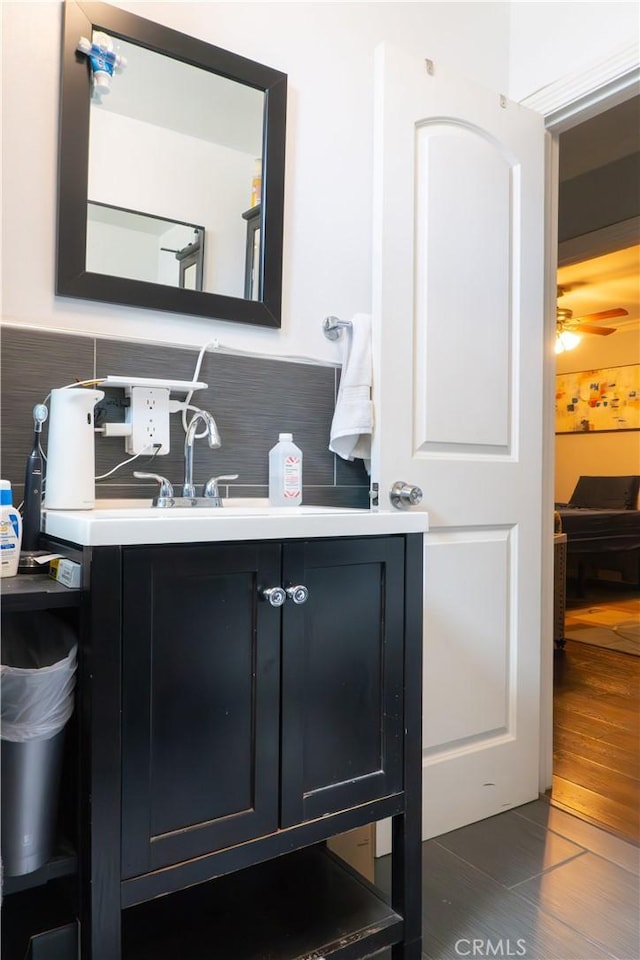 3801 Whiteside St, Los Angeles, CA 90063 - bathroom with decorative backsplash, wood finished floors, vanity, and ceiling fan