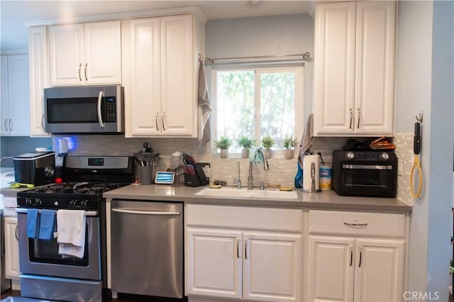 3801 Whiteside St, Los Angeles, CA 90063 - kitchen featuring appliances with stainless steel finishes, white cabinetry, decorative backsplash, and light countertops
