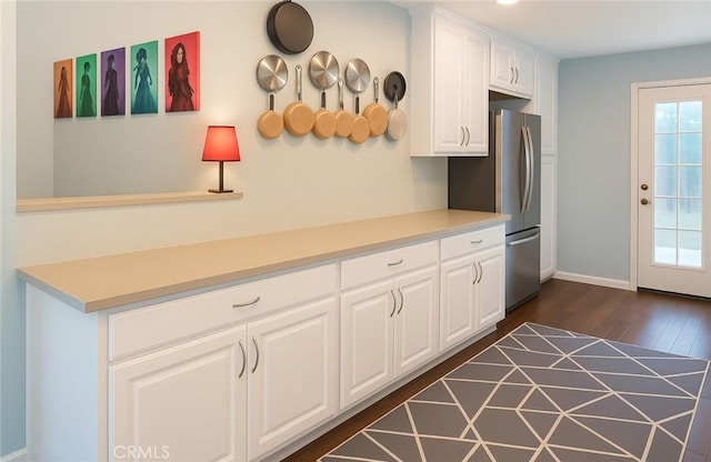 3801 Whiteside St, Los Angeles, CA 90063 - kitchen with freestanding refrigerator, dark wood finished floors, white cabinetry, and light countertops