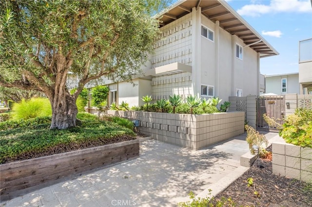 1722 Westcliff Dr Unit 11, Newport Beach, CA 92660 - view of home's exterior with a gate, stucco siding, and a patio