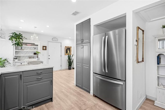 1722 Westcliff Dr Unit 11, Newport Beach, CA 92660 - kitchen featuring freestanding refrigerator, gray cabinetry, light wood-style flooring, recessed lighting, and light countertops
