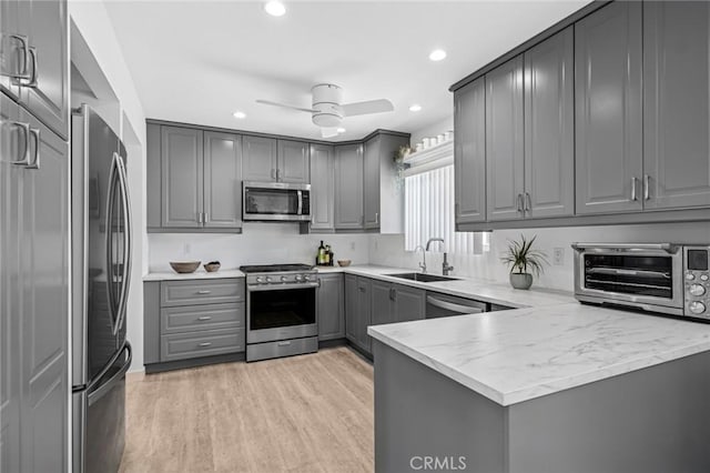 1722 Westcliff Dr Unit 11, Newport Beach, CA 92660 - kitchen featuring stainless steel appliances, gray cabinetry, a peninsula, light wood-type flooring, and recessed lighting