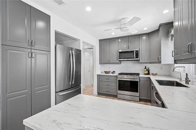 1722 Westcliff Dr Unit 11, Newport Beach, CA 92660 - kitchen featuring appliances with stainless steel finishes, gray cabinetry, ceiling fan, recessed lighting, and light stone countertops