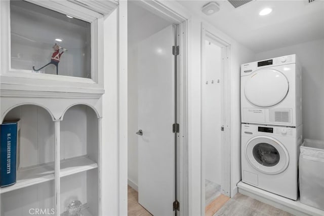 1722 Westcliff Dr Unit 11, Newport Beach, CA 92660 - laundry room featuring stacked washer / dryer and wood finished floors
