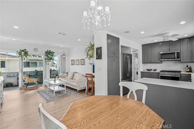 1722 Westcliff Dr Unit 11, Newport Beach, CA 92660 - dining area featuring stacked washer and clothes dryer, recessed lighting, light wood-style flooring, and a chandelier