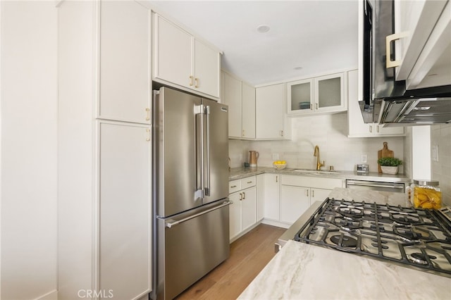 2721 184th St, Redondo Beach, CA 90278 - kitchen featuring appliances with stainless steel finishes, light wood-style flooring, white cabinets, tasteful backsplash, and glass insert cabinets