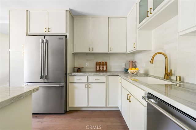 2721 184th St, Redondo Beach, CA 90278 - kitchen with stainless steel appliances, backsplash, wood finished floors, and light stone counters