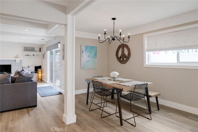 19125 Anza Ave, Torrance, CA 90503 - dining space with light wood-type flooring, a chandelier, a tiled fireplace, beam ceiling, and recessed lighting