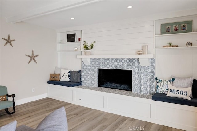 19125 Anza Ave, Torrance, CA 90503 - living area featuring beam ceiling, wood finished floors, a tiled fireplace, and recessed lighting