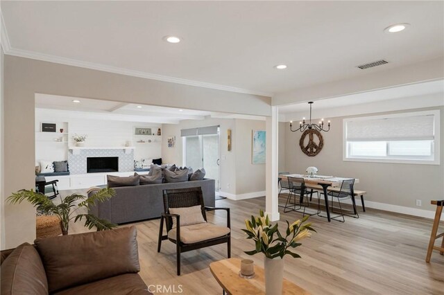 19125 Anza Ave, Torrance, CA 90503 - living area featuring a chandelier, crown molding, recessed lighting, light wood-type flooring, and a tiled fireplace