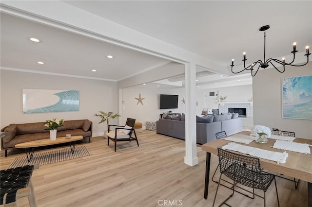19125 Anza Ave, Torrance, CA 90503 - dining space featuring light wood-style floors, a chandelier, recessed lighting, crown molding, and a fireplace