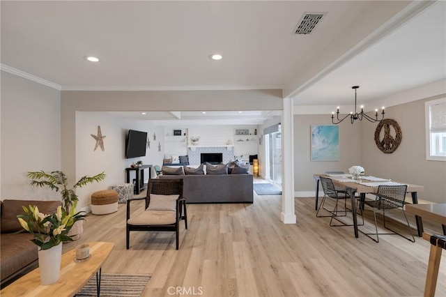 19125 Anza Ave, Torrance, CA 90503 - living room featuring light wood-type flooring, a fireplace, a chandelier, ornamental molding, and recessed lighting