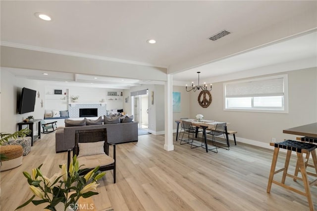 19125 Anza Ave, Torrance, CA 90503 - living area featuring a chandelier, light wood-style floors, a fireplace, recessed lighting, and ornamental molding