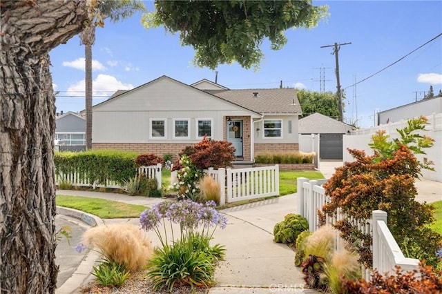 19125 Anza Ave, Torrance, CA 90503 - view of front facade with brick siding, a fenced front yard, a detached garage, and concrete driveway