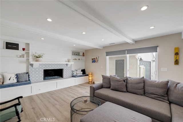 19125 Anza Ave, Torrance, CA 90503 - living room featuring wood finished floors, beam ceiling, a tiled fireplace, and recessed lighting