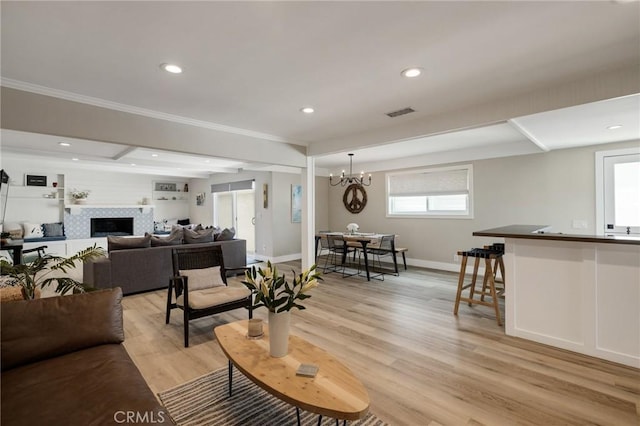19125 Anza Ave, Torrance, CA 90503 - living room with light wood-style flooring, a tile fireplace, recessed lighting, and a chandelier