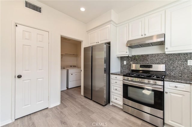357 Flyers Ln, Tustin, CA 92782 - kitchen with appliances with stainless steel finishes, under cabinet range hood, separate washer and dryer, white cabinets, and recessed lighting