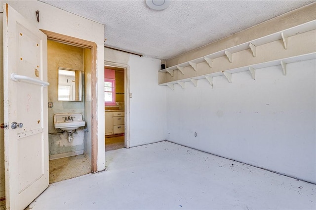 1510 E 53rd St, Long Beach, CA 90805 - unfurnished bedroom featuring concrete flooring, ensuite bath, and a textured ceiling