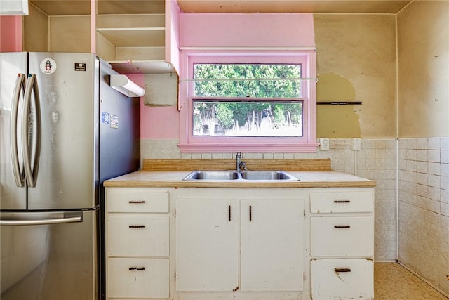 1510 E 53rd St, Long Beach, CA 90805 - kitchen featuring freestanding refrigerator, light countertops, white cabinetry, tile walls, and a wainscoted wall